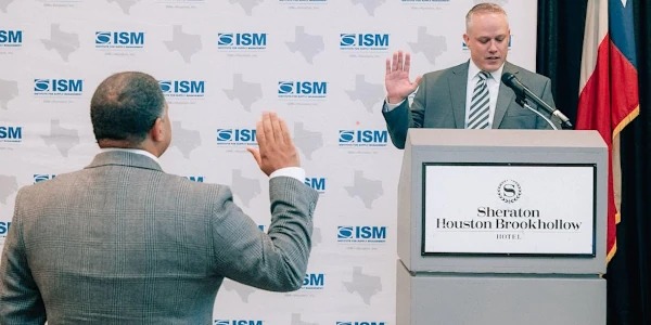 Picture of man giving the oath of office for another man as an officer of ISM-Houston.